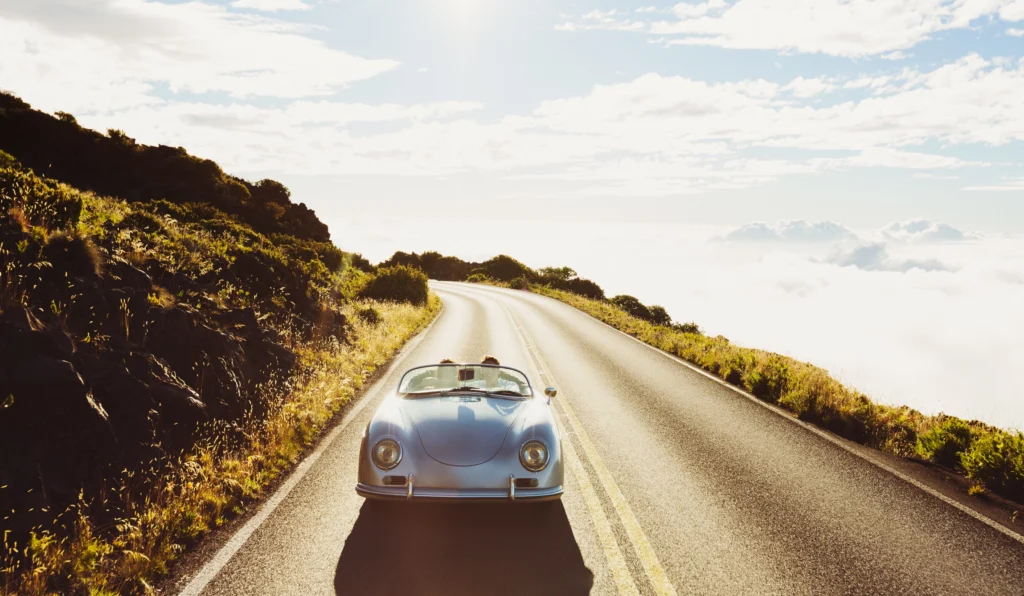 Classic roadster on a coastal road